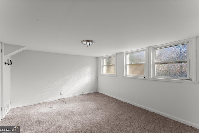 unfurnished room featuring carpet flooring and baseboards