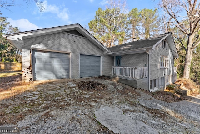 view of front of home with a garage, brick siding, fence, concrete driveway, and a chimney