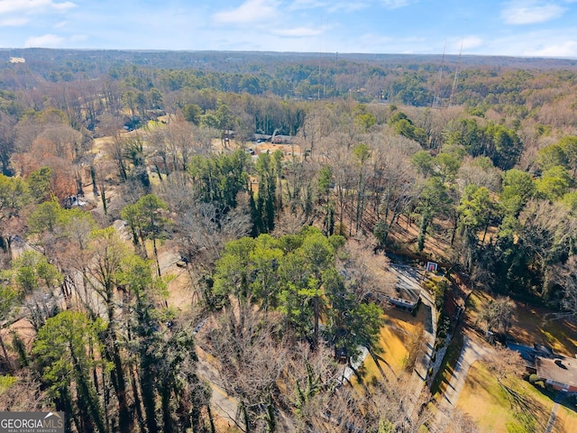 birds eye view of property with a view of trees