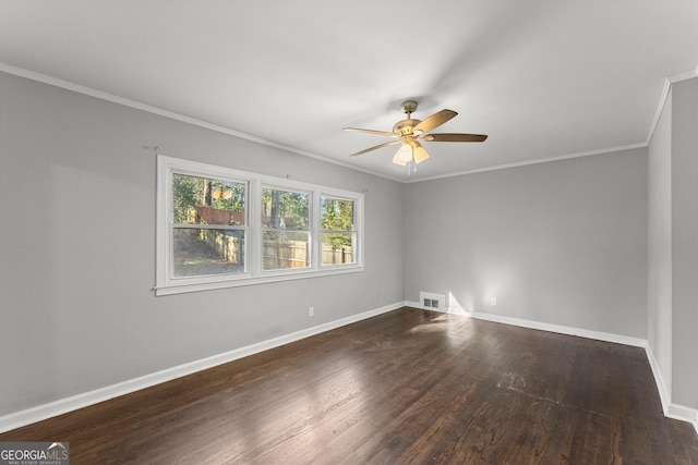 unfurnished room featuring crown molding, visible vents, dark wood-type flooring, a ceiling fan, and baseboards