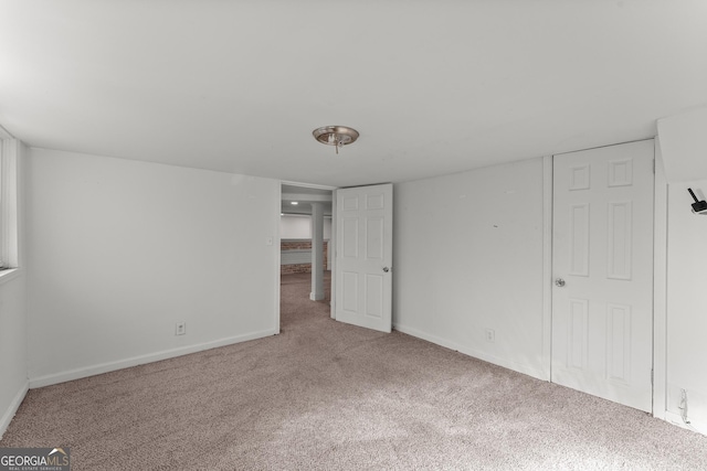 unfurnished bedroom featuring carpet and baseboards