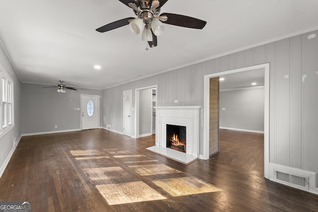 unfurnished living room featuring visible vents, baseboards, wood-type flooring, crown molding, and a brick fireplace