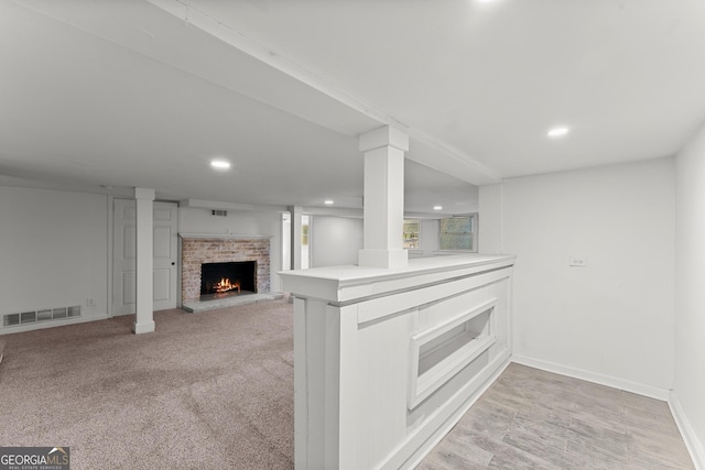 kitchen with recessed lighting, visible vents, baseboards, light countertops, and a brick fireplace