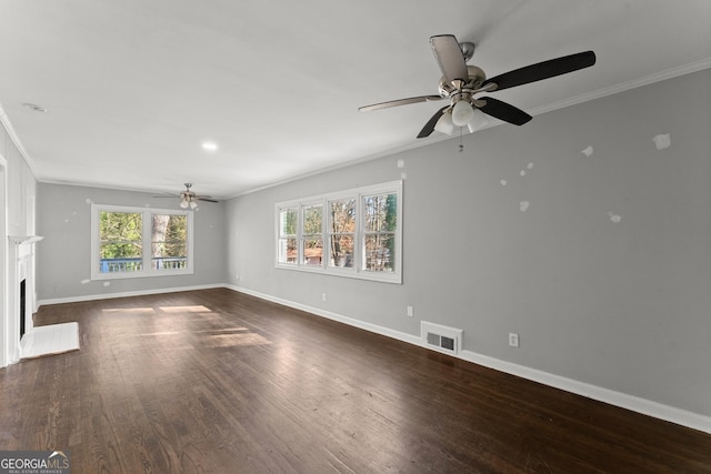 unfurnished living room featuring dark wood finished floors, visible vents, and crown molding