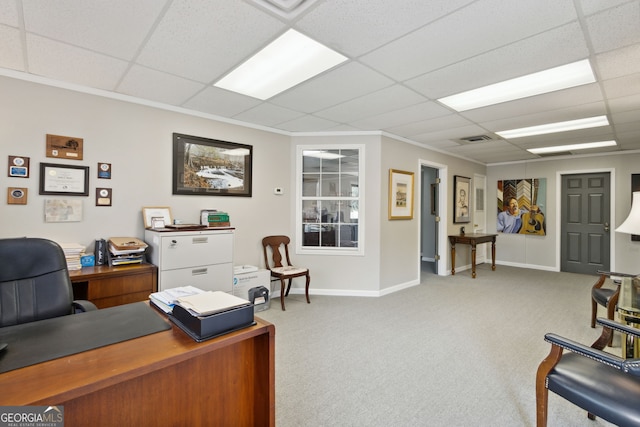 carpeted office featuring a paneled ceiling, visible vents, crown molding, and baseboards