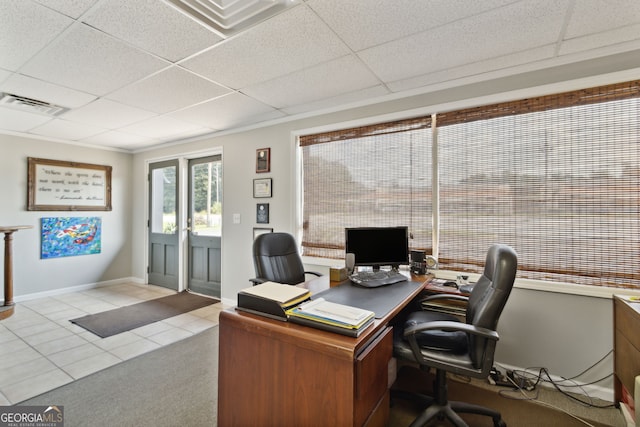 office space with a paneled ceiling, visible vents, and light tile patterned flooring