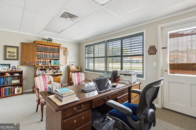 home office with carpet floors, visible vents, a drop ceiling, and baseboards