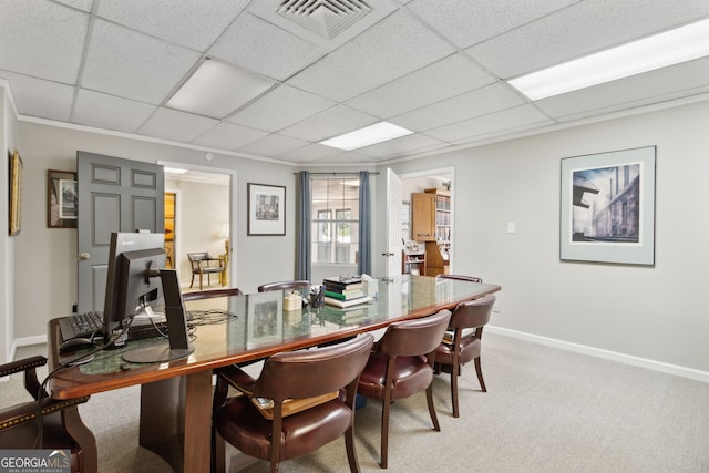 dining space featuring a paneled ceiling, light colored carpet, visible vents, and baseboards