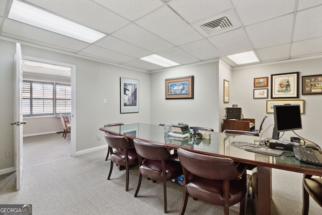 carpeted dining room featuring a paneled ceiling, visible vents, and baseboards