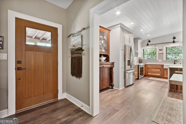 foyer with recessed lighting, baseboards, and wood finished floors