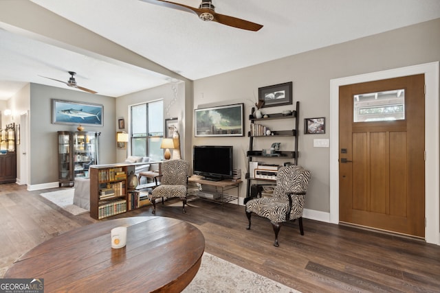 living room with ceiling fan, wood finished floors, and baseboards