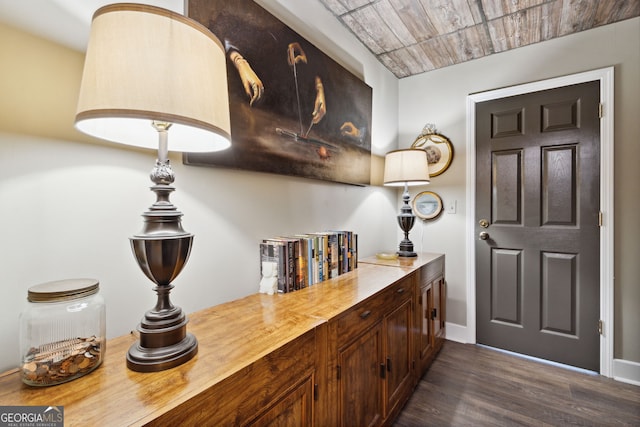 bar with dark wood-type flooring