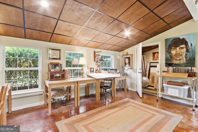 dining space featuring lofted ceiling and baseboards