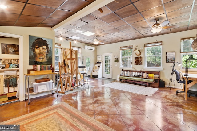 foyer featuring rail lighting, a wall mounted AC, ceiling fan, tile patterned flooring, and baseboards