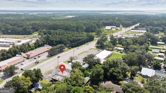 drone / aerial view featuring a view of trees