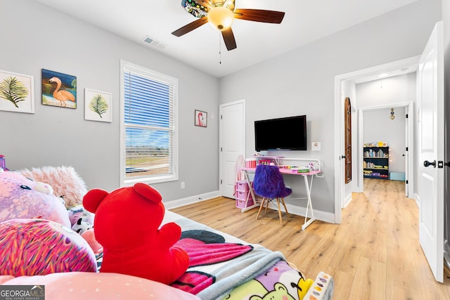 bedroom featuring baseboards, attic access, visible vents, and wood finished floors