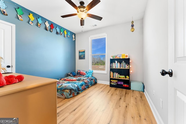 bedroom with visible vents, baseboards, ceiling fan, and wood finished floors