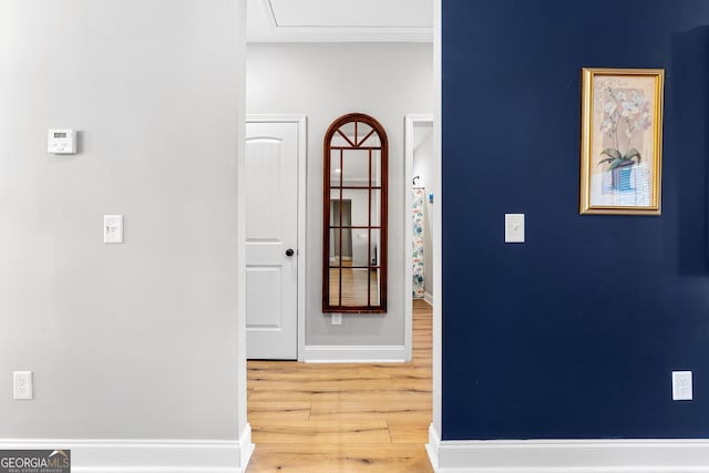 hall featuring baseboards and wood finished floors