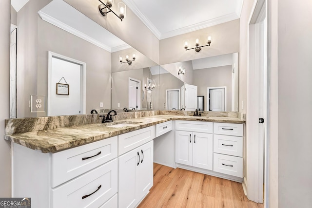 bathroom featuring double vanity, wood finished floors, a sink, and crown molding