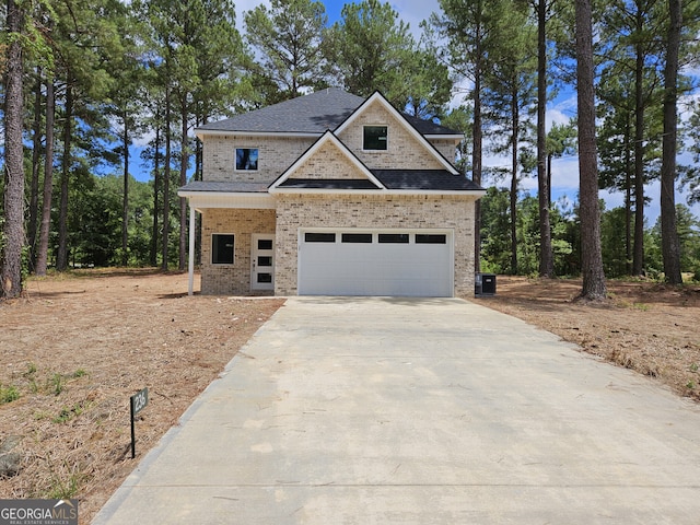 view of front of house with a garage, concrete driveway, and brick siding