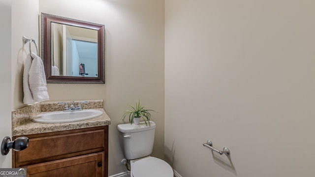 half bathroom featuring toilet and vanity