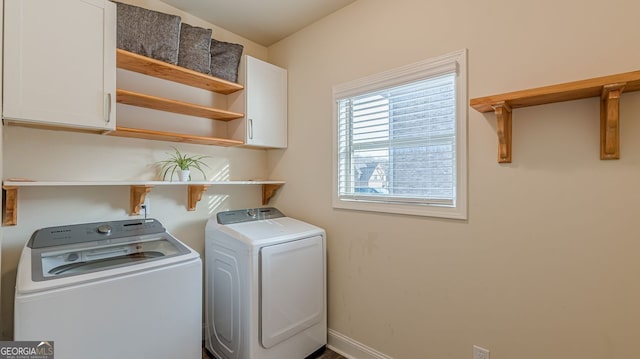 washroom featuring cabinet space, baseboards, and independent washer and dryer