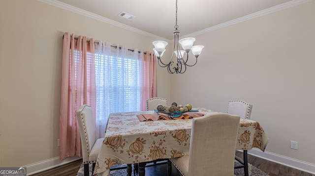 dining space featuring ornamental molding, dark wood finished floors, visible vents, and an inviting chandelier