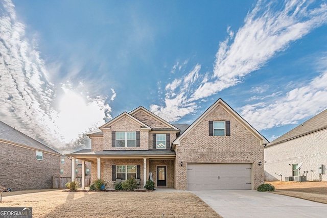 view of front of property with covered porch, driveway, brick siding, and an attached garage