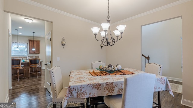 dining room with ornamental molding, dark wood-type flooring, baseboards, and a notable chandelier