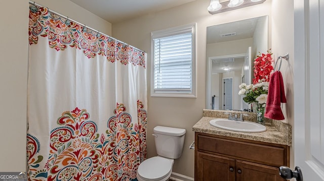 full bathroom with toilet, visible vents, a shower with shower curtain, and vanity