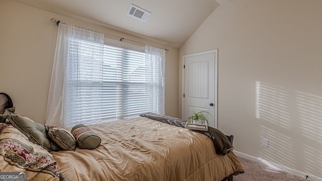 carpeted bedroom featuring lofted ceiling, visible vents, and baseboards