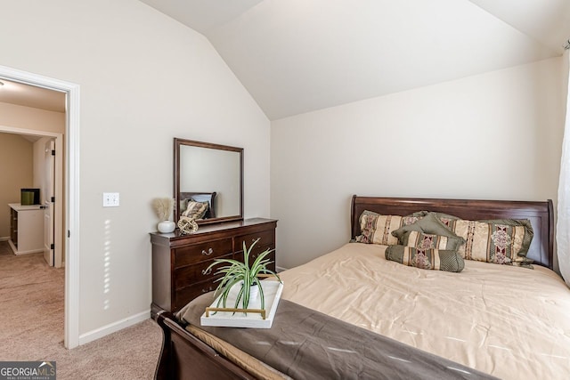 carpeted bedroom featuring vaulted ceiling and baseboards