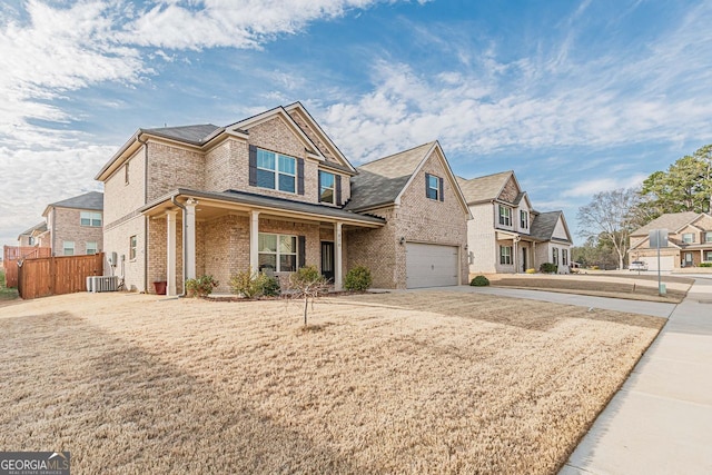 view of front facade featuring driveway, central AC unit, an attached garage, fence, and brick siding