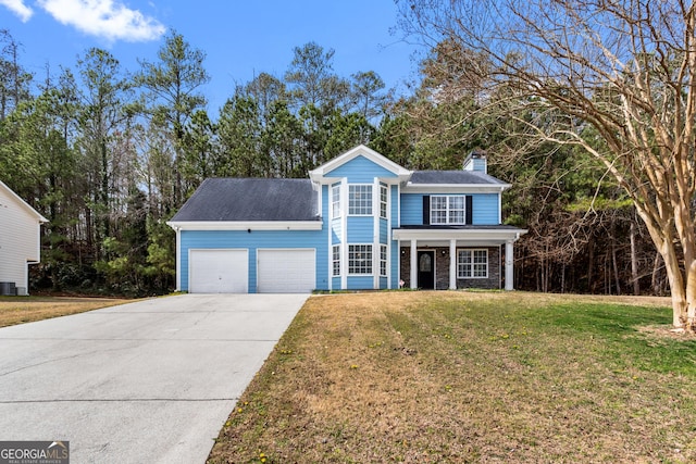 traditional-style house with a chimney, a porch, an attached garage, a front yard, and driveway