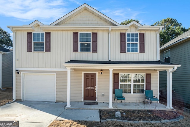 view of front of house featuring a garage, a porch, and concrete driveway