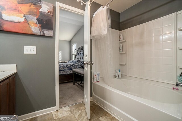 5987 Westchase St, Atlanta, GA 30336 - full bath featuring bathing tub / shower combination, ensuite bathroom, vaulted ceiling, vanity, and baseboards
