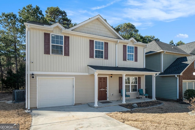 view of front of home featuring a garage, driveway, a porch, and cooling unit