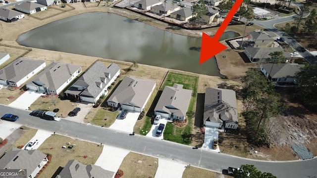 bird's eye view featuring a water view and a residential view