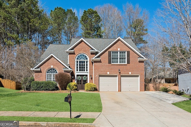 traditional home featuring driveway, a garage, roof with shingles, a front lawn, and brick siding