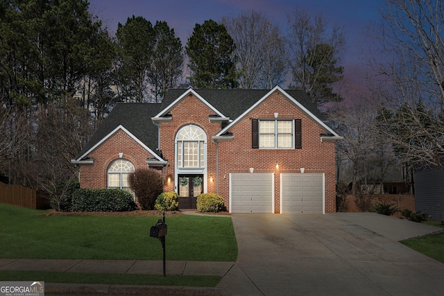 traditional-style house with brick siding, roof with shingles, concrete driveway, a front yard, and a garage