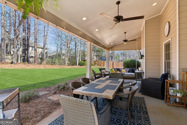 view of patio featuring outdoor dining area, ceiling fan, fence, and outdoor lounge area