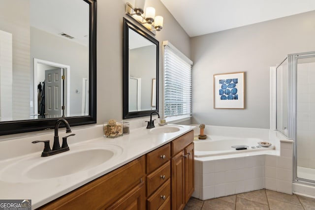 full bath with visible vents, a sink, a shower stall, and a bath