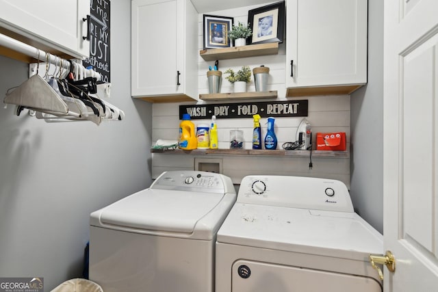 laundry area featuring separate washer and dryer and cabinet space