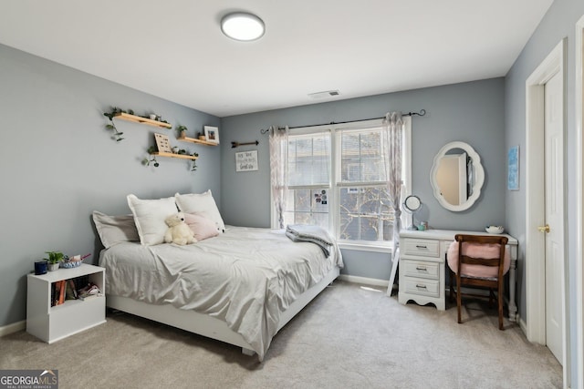 bedroom with visible vents, light carpet, and baseboards