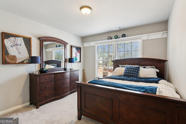 bedroom featuring light colored carpet, visible vents, and baseboards