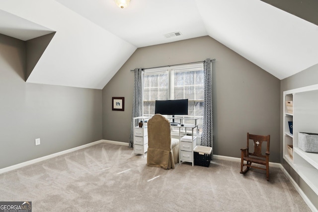 office space featuring vaulted ceiling, carpet, visible vents, and baseboards