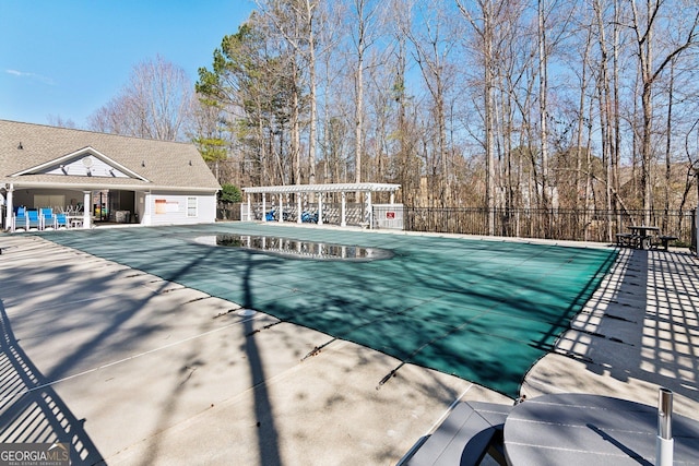 pool featuring a patio area, fence, and a pergola