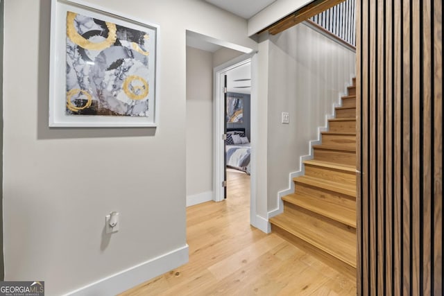 stairs featuring baseboards and wood finished floors