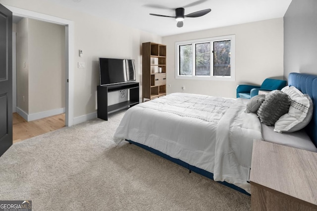 carpeted bedroom featuring ceiling fan and baseboards