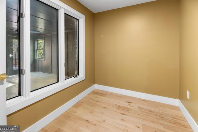 empty room featuring wood finished floors and baseboards